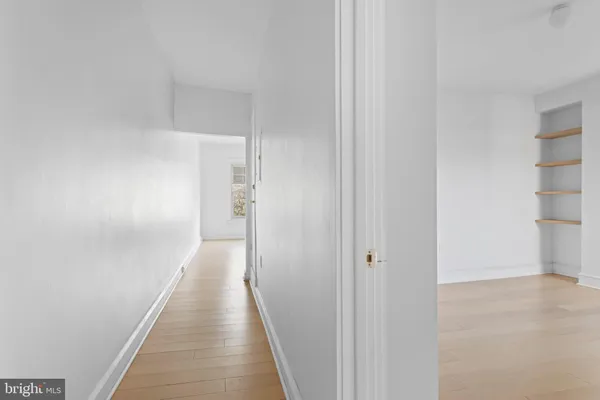 a view of a hallway with a wooden floors