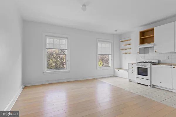 a view of a kitchen with microwave and stove top oven