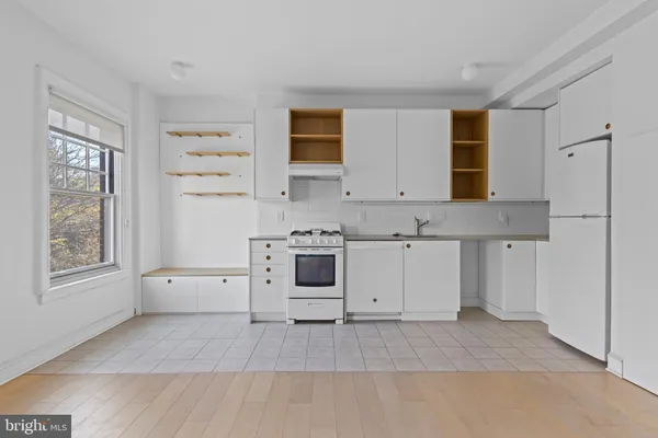 a view of white cabinets and window
