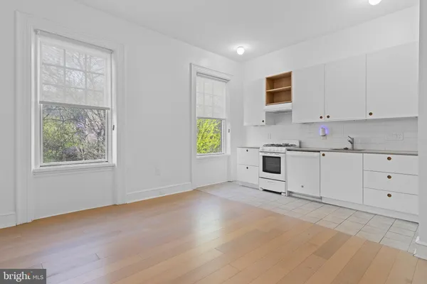 a kitchen with cabinets and window