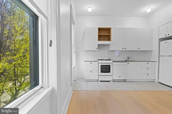 a view of a kitchen with electric appliances
