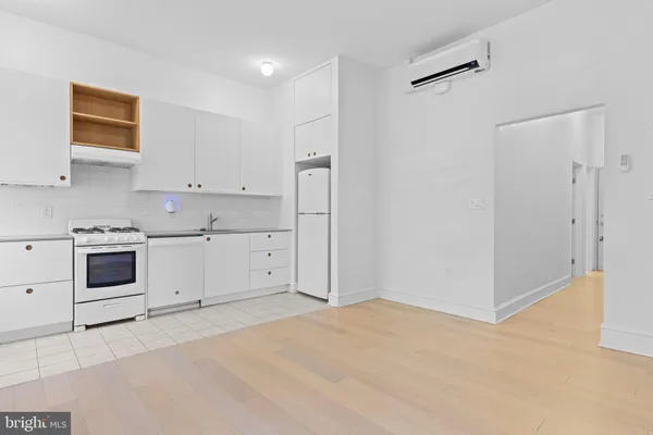 a view of a kitchen with white cabinets