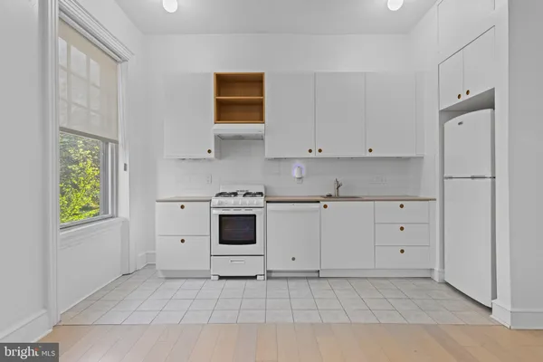 a view of white cabinets and window