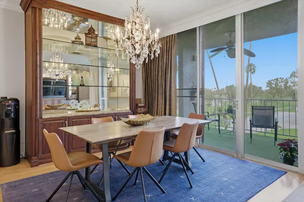 a view of a dining room with furniture wooden floor and chandelier