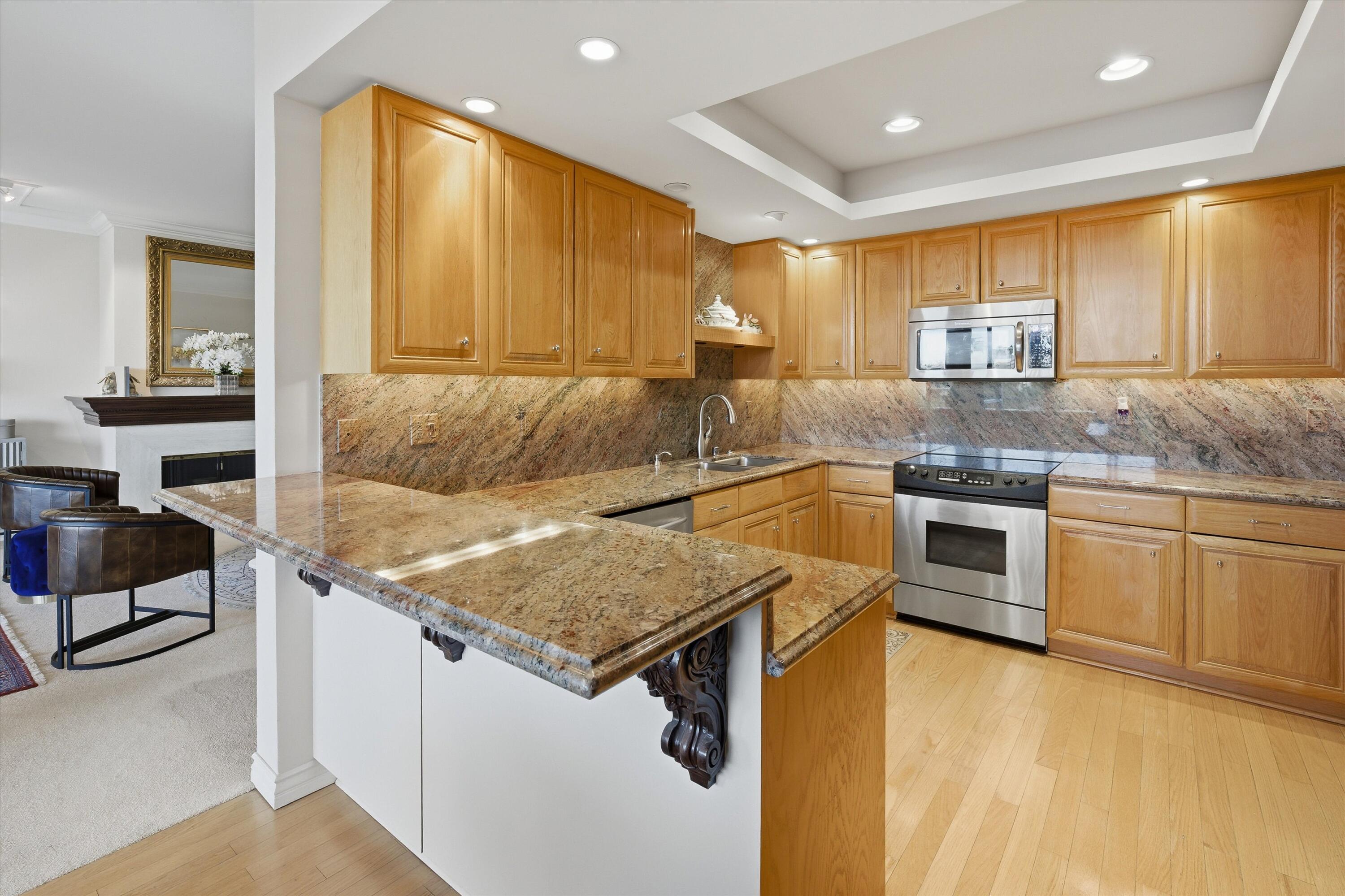 900 Island Drive, Unit 304 Rancho Mirage, CA 92270 - Photo 20 of 40 a kitchen with a stove a sink and a refrigerator