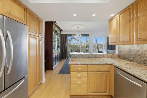 a kitchen with stainless steel appliances granite countertop a refrigerator and a sink
