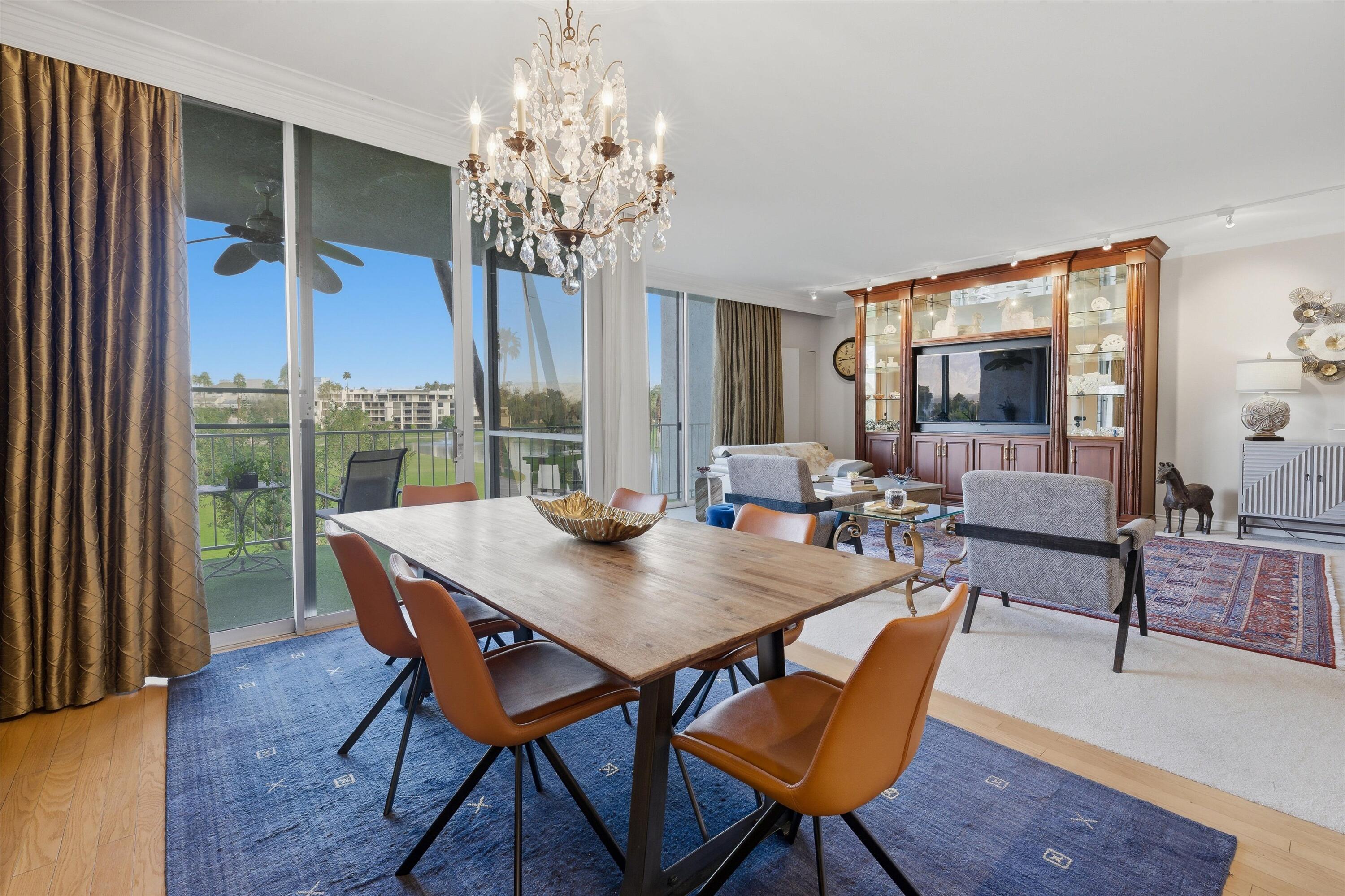 900 Island Drive, Unit 304 Rancho Mirage, CA 92270 - Photo 24 of 40 a view of a dining room with furniture window and wooden floor