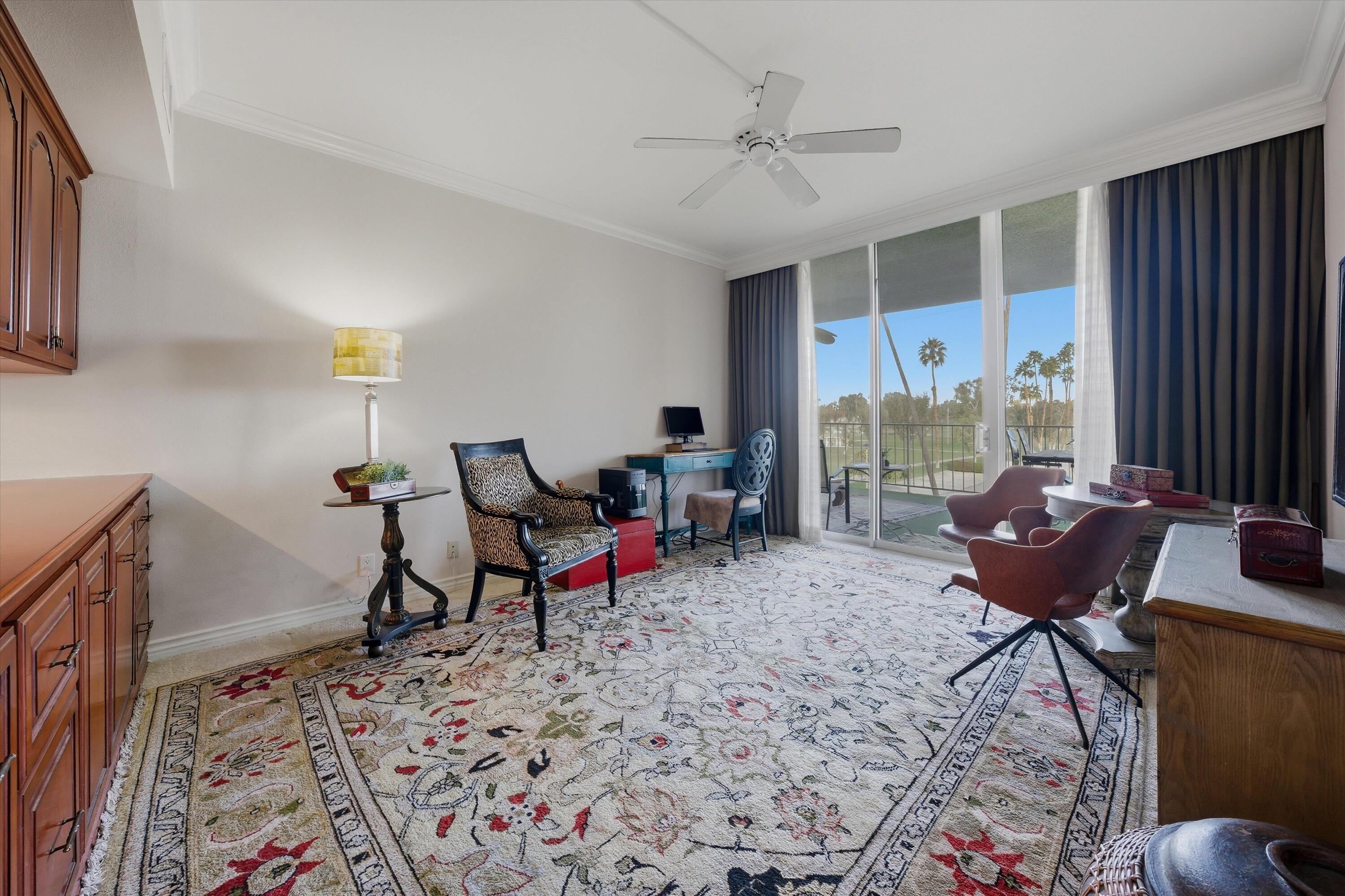 900 Island Drive, Unit 304 Rancho Mirage, CA 92270 - Photo 25 of 40 a living room with furniture a rug and a window