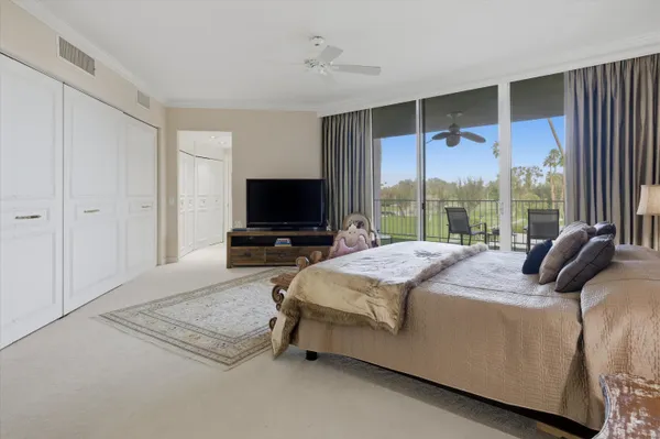 a bedroom with a bed and large window
