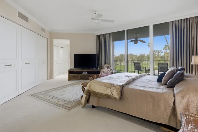 a bedroom with a bed and large window