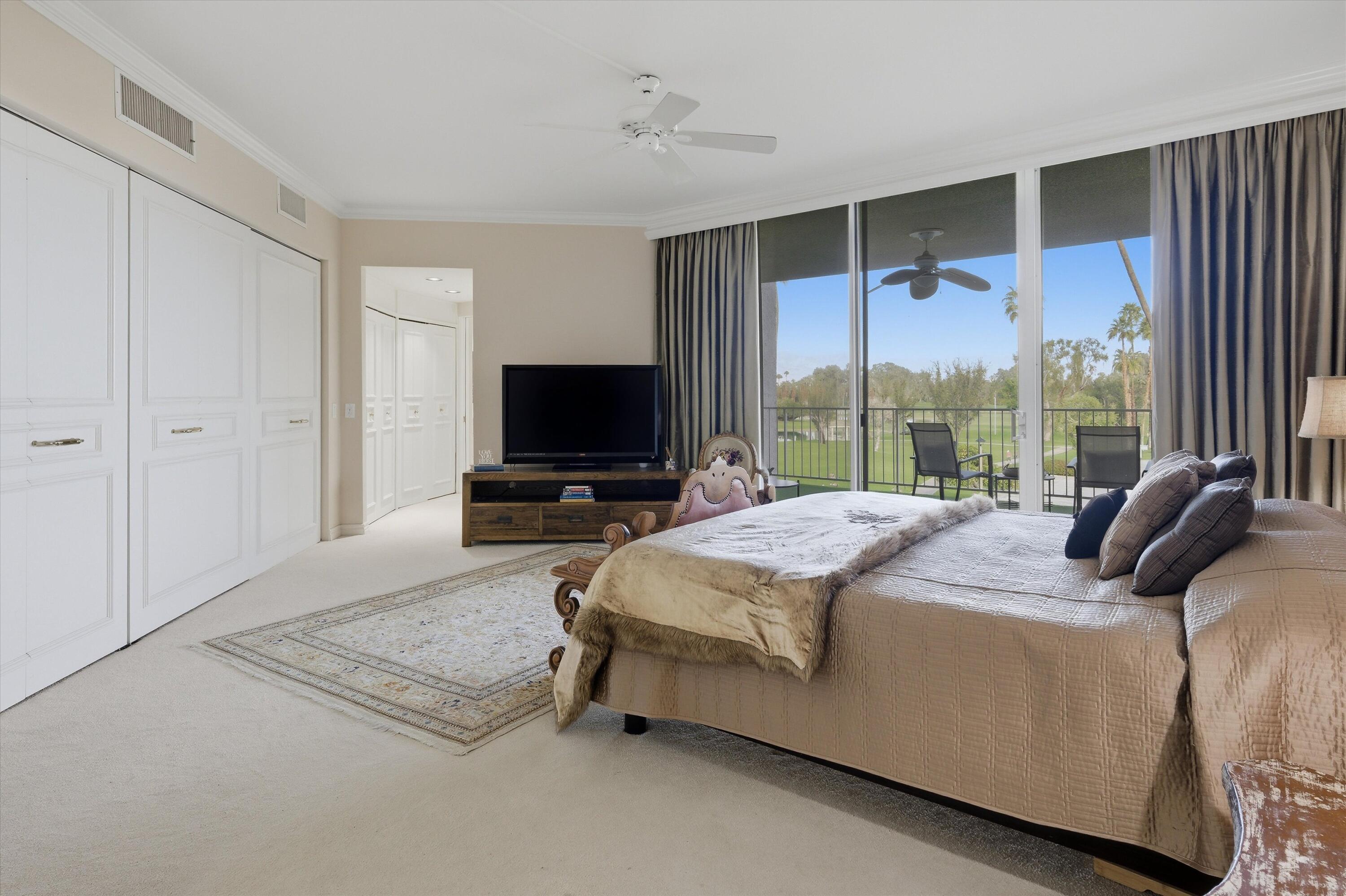 900 Island Drive, Unit 304 Rancho Mirage, CA 92270 - Photo 30 of 40 a bedroom with a bed and large window