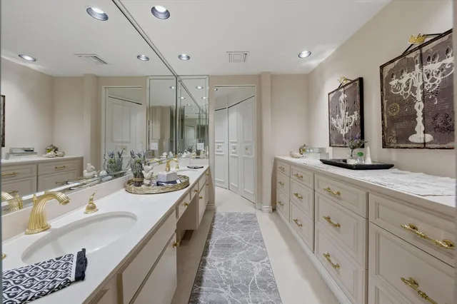 a spacious bathroom with double vanity and a mirror