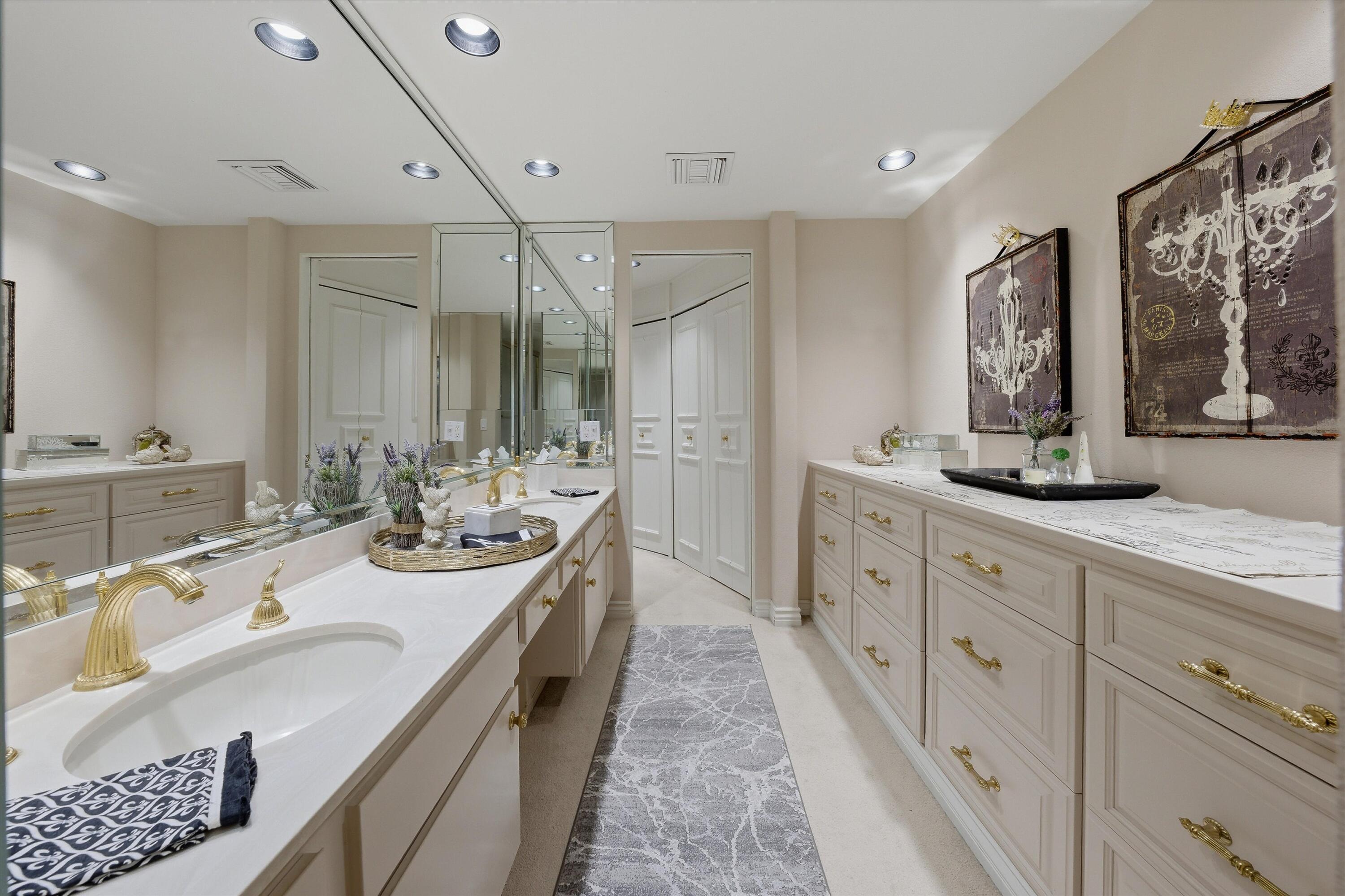 900 Island Drive, Unit 304 Rancho Mirage, CA 92270 - Photo 32 of 40 a spacious bathroom with double vanity and a mirror