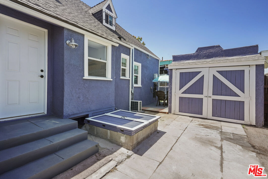 1675 West Boulevard Los Angeles, CA 90019 - Photo 1 of 1 a backyard of a house with couch and a table