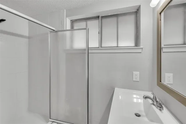 a bathroom with a sink and shower