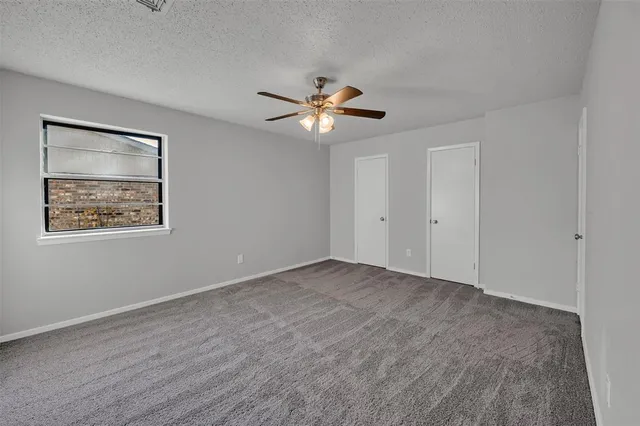 a view of an empty room with a fan