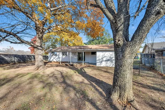 a view of a house with snow on the tree