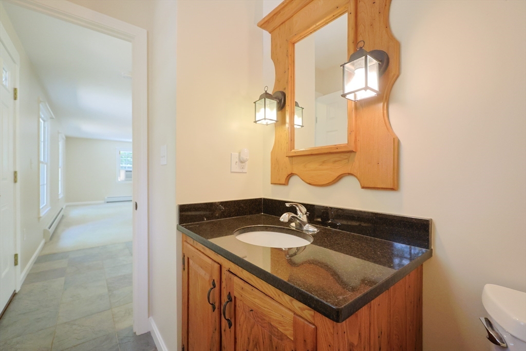 68 Dresser Hill Road, Unit 2 Dudley, MA 01571 - Photo 15 of 39 a bathroom with a sink and a mirror