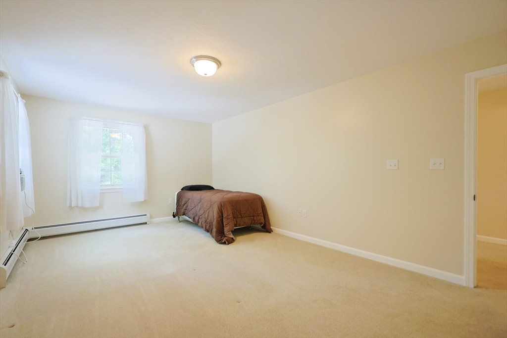 68 Dresser Hill Road, Unit 2 Dudley, MA 01571 - Photo 18 of 39 a room with a bed and a window