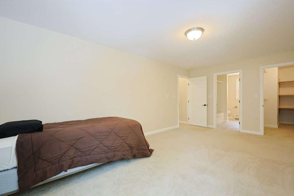 68 Dresser Hill Road, Unit 2 Dudley, MA 01571 - Photo 19 of 39 a bedroom with a bed and a cabinets