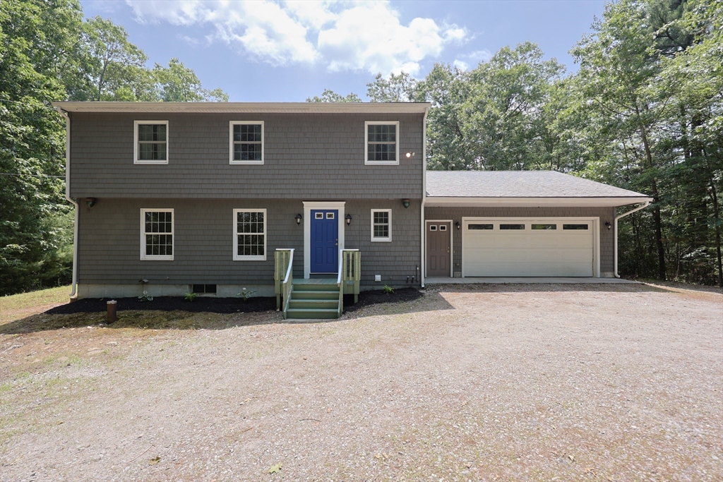 68 Dresser Hill Road, Unit 2 Dudley, MA 01571 - Photo 2 of 39 front view of a house with a yard