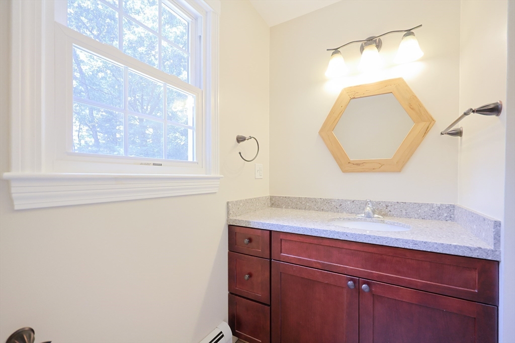 68 Dresser Hill Road, Unit 2 Dudley, MA 01571 - Photo 22 of 39 a bathroom with a sink and a mirror