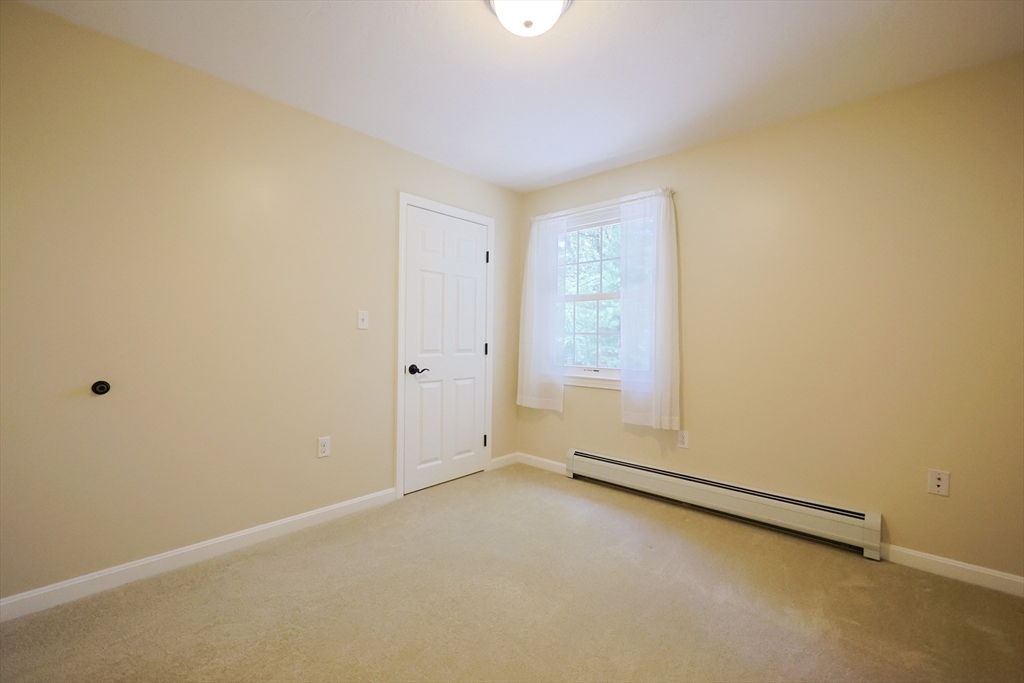 68 Dresser Hill Road, Unit 2 Dudley, MA 01571 - Photo 25 of 39 an empty room with a empty space and window