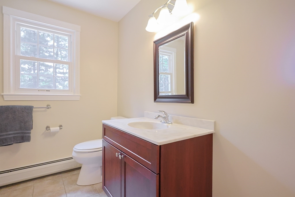 68 Dresser Hill Road, Unit 2 Dudley, MA 01571 - Photo 29 of 39 a bathroom with a toilet sink and mirror