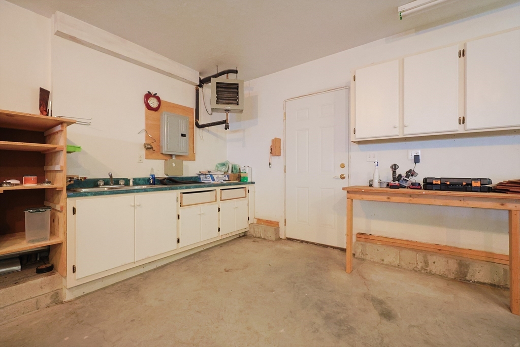 68 Dresser Hill Road, Unit 2 Dudley, MA 01571 - Photo 32 of 39 a kitchen with granite countertop white cabinets and white appliances