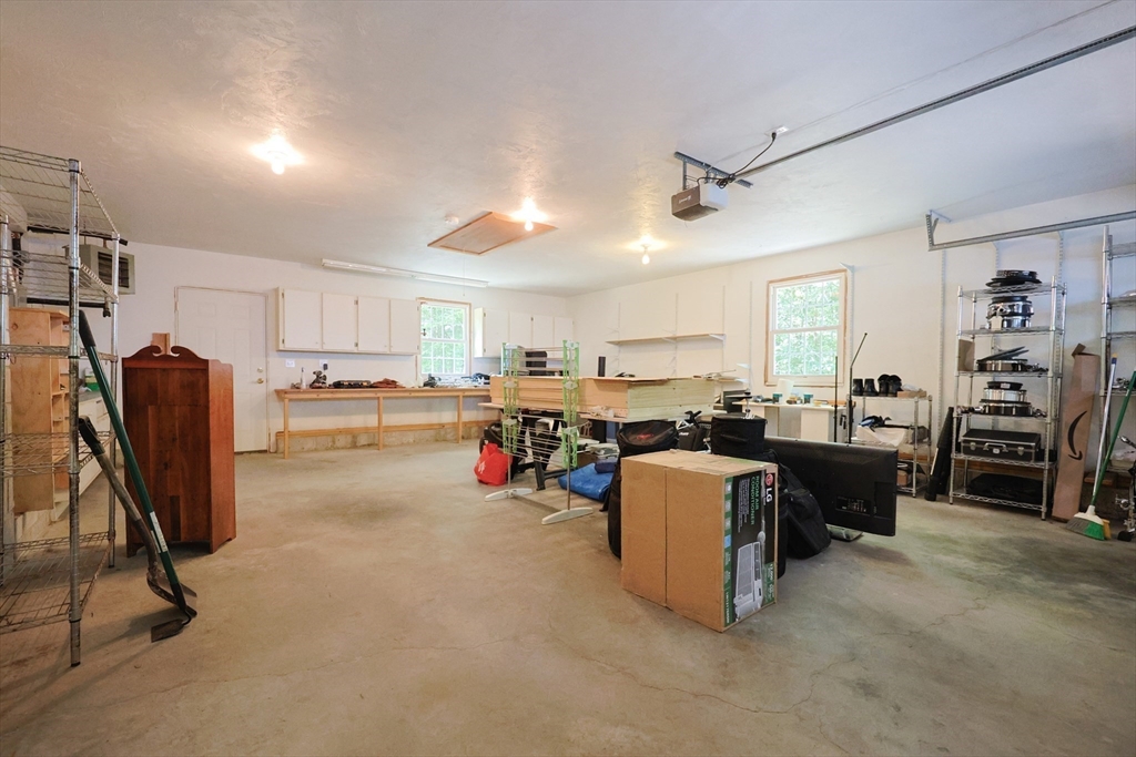 68 Dresser Hill Road, Unit 2 Dudley, MA 01571 - Photo 34 of 39 a view of a kitchen with furniture and a refrigerator