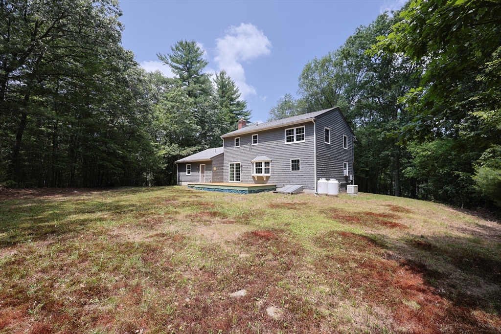 68 Dresser Hill Road, Unit 2 Dudley, MA 01571 - Photo 37 of 39 a view of a house with backyard and trees