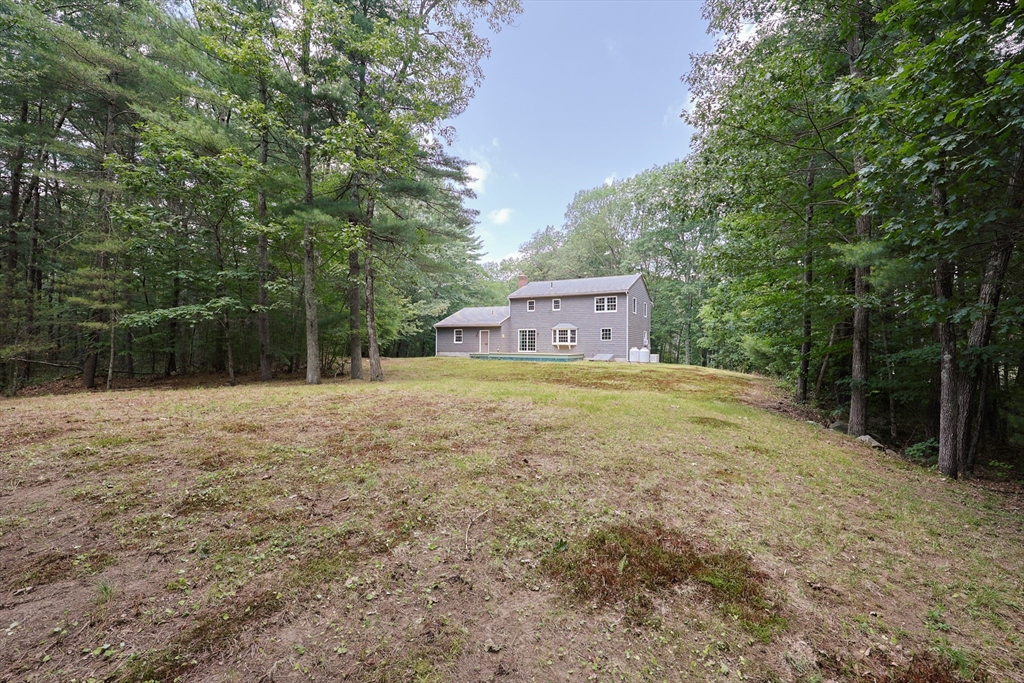 68 Dresser Hill Road, Unit 2 Dudley, MA 01571 - Photo 38 of 39 a house with trees in front of it
