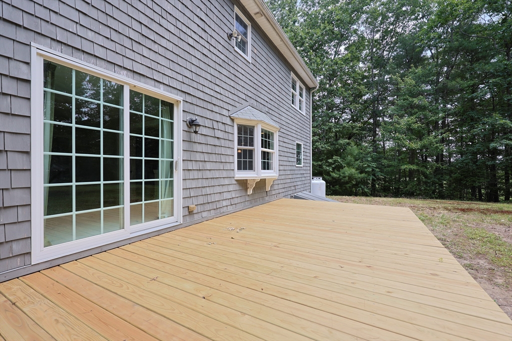 68 Dresser Hill Road, Unit 2 Dudley, MA 01571 - Photo 39 of 39 a front view of a house with a yard