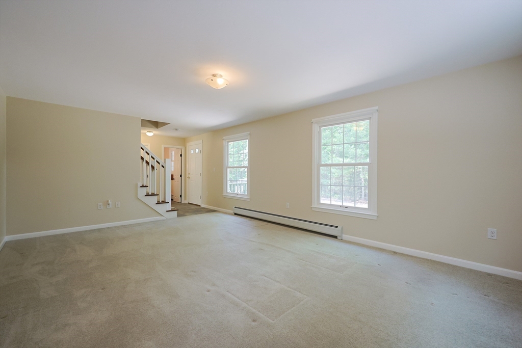 68 Dresser Hill Road, Unit 2 Dudley, MA 01571 - Photo 4 of 39 an empty room with windows