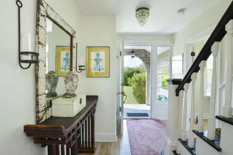a view of a hallway with furniture and front door