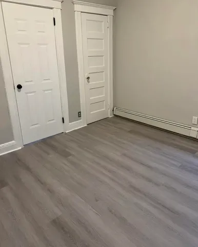 an empty room with wooden floor