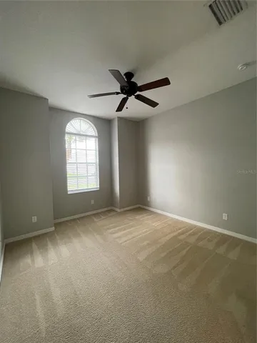 a bathroom with a granite countertop sink a toilet and a mirror