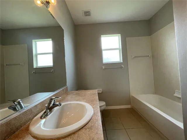 a view of a bathroom with a glass door shower and a sink
