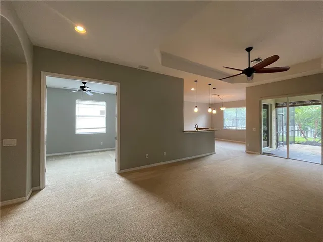 a view of a livingroom with a ceiling fan and window