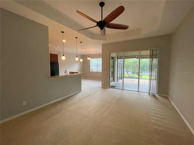 a large kitchen with a large island in the center a sink a counter space and cabinets