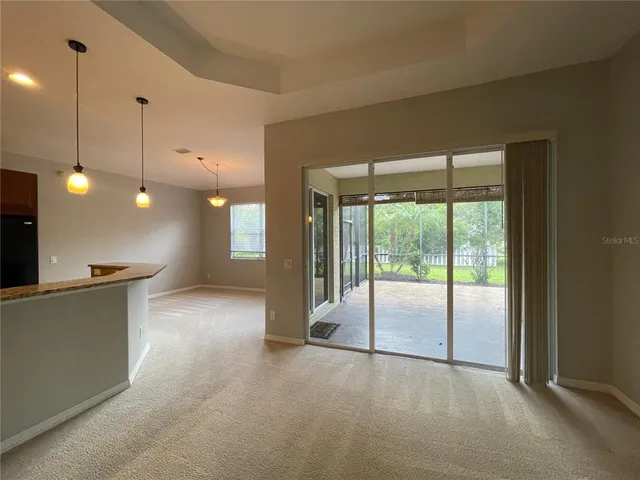 a kitchen with stainless steel appliances granite countertop a refrigerator a stove top oven a sink dishwasher and wooden cabinets with wooden floor