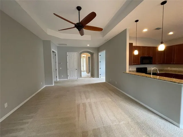 a kitchen with stainless steel appliances granite countertop wooden cabinets a stove a sink and a refrigerator