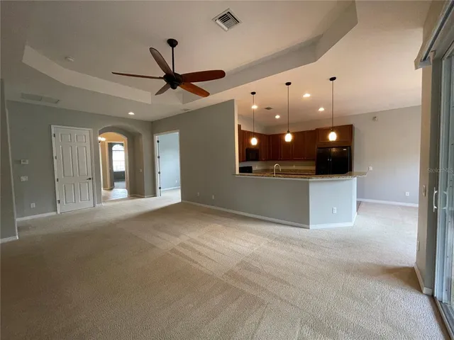 a kitchen with stainless steel appliances granite countertop a sink a stove top oven a counter space and cabinets