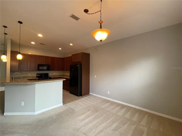a bathroom with a granite countertop sink a mirror and a toilet