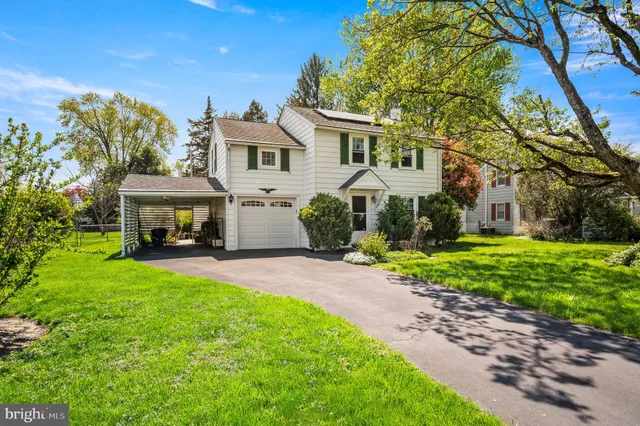 a front view of a house with garden and porch