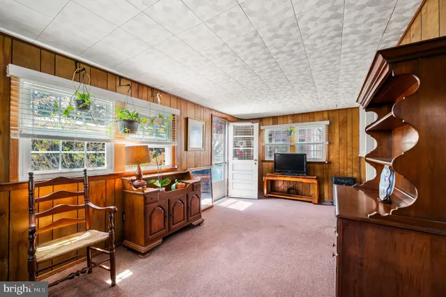 a bedroom with furniture and a large window