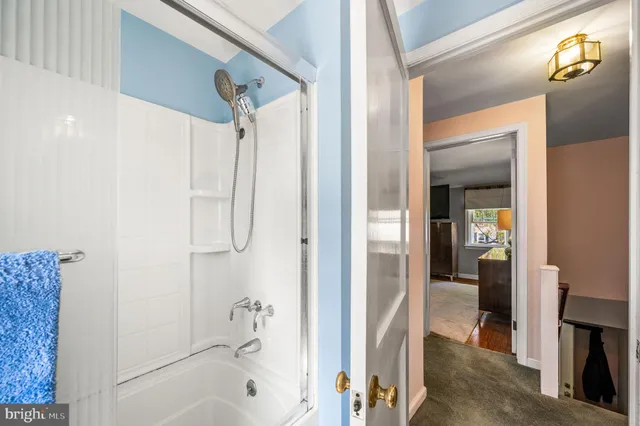 a bathroom with a tub and shower