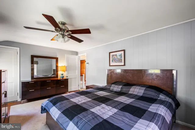 a bedroom with a bed and a dresser