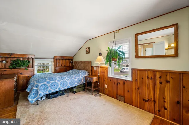 a bedroom with furniture and a window