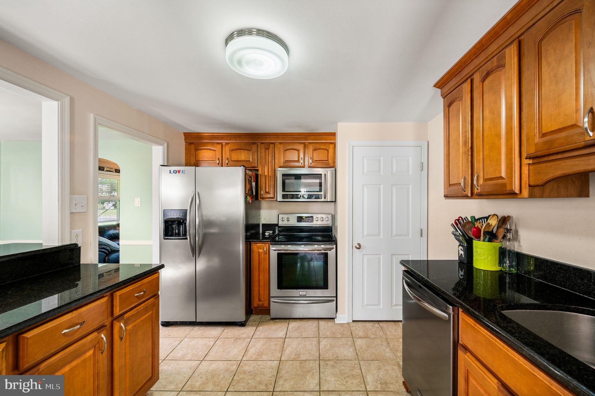 416 Preston Lane Hatboro, PA 19040 - Photo 2 of 24 a kitchen with stainless steel appliances granite countertop a refrigerator a stove and a sink